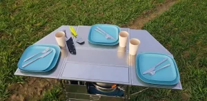 Top view of the Dare to be Different M-size chuckbox, fully opened and organized for outdoor cooking.